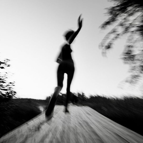Blurry artistic shot of person in motion during exercise.